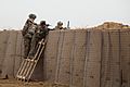 U.S. Soldiers and Afghan soldiers provide security while standing behind HESCO barriers during strongpoint construction at Zharay district, Kandahar province, Afghanistan, Feb 120210-A-QD683-134