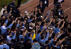 Uruguay players with CA trophy.jpg