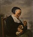 David Ryckaert (III) - Old women smelling a carnation (Allegory of smell)