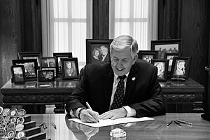 Mike Parson signing a bill B&W