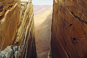 Sunrise thru cleft, Vermilion Cliffs National Monument, Arizona, USA
