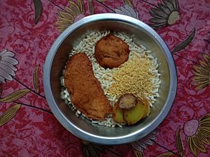 Puffed rice with Telebhaja (Bengali fritters), and potato fries in West Bengal, India