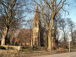 Victorian Gothic Revival church with spire among trees