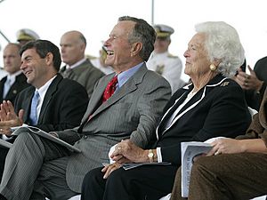 George H. W. Bush and Barbara Bush laugh during George H.W. Bush (CVN 77) christening