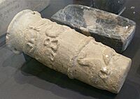 Limestone cylinder jar with falcons, scorpions, bows and birds in raised relief. From the 'Main Deposit' at Hierokonpolis. E. 347. (Ashmolean)