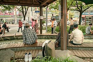 People take a foot bath at an outdoor public hot spring in Yuseong-gu, Daejeon, Korea