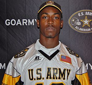 American football player in a hat and jersey both with US Army insignia.