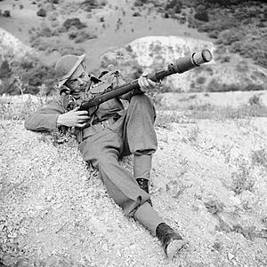 A member of the Home Guard demonstrates a rifle equipped to fire an anti-tank grenade, Dorking, 3 August 1942. H22061