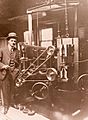 Earl R. Dean standing with the johnny bull machine