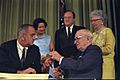 Photograph of President Lyndon Johnson Hands President Harry S. Truman a Pen at the Signing of the Medicare Bill at the Harry S. Truman Library, Independence, Missouri