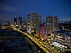 Aerial view of Gurney Drive, lined with skyscrapers, at dusk