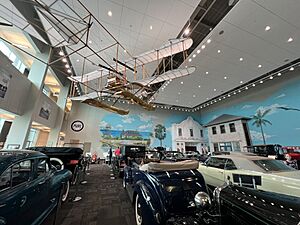 Vintage airplane above the automobile exhibit at the Elliot Museum