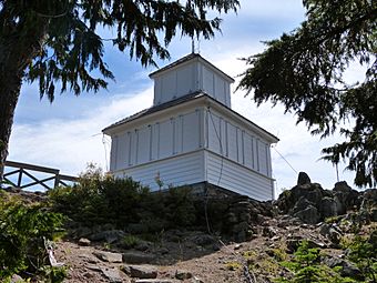 Photograph of a small whitewashed building on a rocky mountaintop