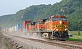 Orange locomotive hauling freight