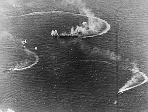 Japanese aircraft carrier Zuikaku and two destroyers under attack
