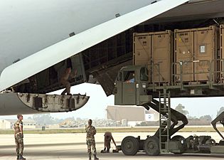 US Navy 060831-N-3560G-052 Members of Naval Mobile Construction Battalion Four (NMCB-4) load Tricon Containers loaded with construction equipment destine for field testing in Iraq, into a U.S. Air Force, Air Mobility Command, C