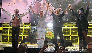 Van Halen standing onstage and waving to the audience