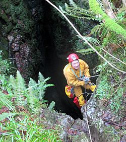 A caver descending Death's Heads Hole entrance shaft