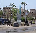 "Photo of a public square in Rashid (Rosetta) in Egypt featuring a replica of the Rosetta Stone"
