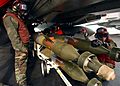 US Navy 050112-N-5345W-074 Aviation Ordnancemen prepare to load 500-pound laser guided bombs (GBU-12) onto weapon pylons under an F-14B Tomcat