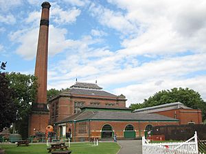 Red-brick industrial building with tall chimney-stack