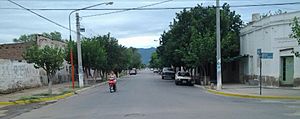 View southwest along Avenida Perón in downtown Chamical. The brushy Sierra de los Quinteros range can be seen in distant background
