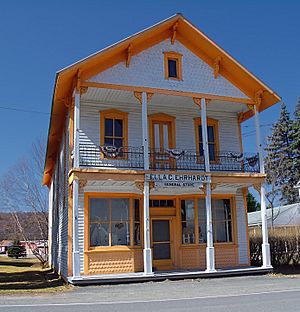 Old-fashioned, two-story building, with white and orange paint. A sign on the front of the building reads "ELLA C. EHRHARDT GENERAL STORE."