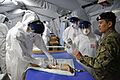 Practising taking blood in Ebola saftey suits (15649429018)