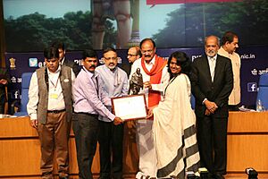 Rourkela Municipal Commissioner and Rourkela ADM taking award from Shri M.Venkaiah Naidu