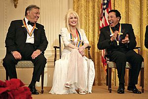 Zubin Mehta laughs with singers Dolly Parton and William Smokey Robinson during a reception for the Kennedy Center honorees