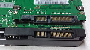 2.5-inch SATA drive on top of a 3.5-inch SATA drive, close-up of data and power connectors