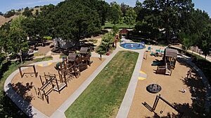 Aerial view of Hap Magee Ranch Park showing childrens playground in the foreground, picnic area on the left and park area in the background
