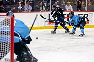 Amy Menke takes a shot at the goal with Emily Pfalzer