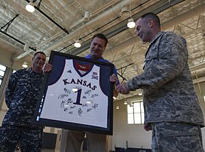 Coach Bill Self presents Air Force Col. Renzy Smith an autographed and framed jersey during a team practice (2979698)