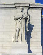 Louis St. Gaudens's allegorical Archimedes statue, representing the gift of mechanics, one of six on the parapet above the entrance to Washington D.C.'s Union Station LCCN2011634506