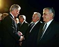President Bill Clinton greeting Ariel Sharon and Yitzhak Mordechai