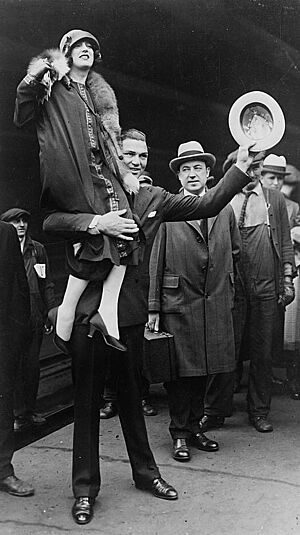 Jack Dempsey carrying his wife