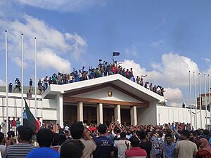 People cheering in front of the Prime Minister's Office after Sheikh Hasina's resignation