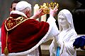 Pope Benedict XVI placing a novelty crown on Our Lady of Lourdes on occasion for the sick pilgrims, 11 February 2007