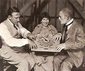 Tod Browning, director (R), with (L to R) actors Polly Moran, Lon Chaney, on the set of London After Midnight (1927)