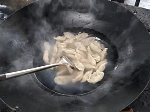 Cooking with a wok on an outdoor stove 3