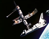 Space Shuttle (US) docked to Mir (USSR/Russia) (1995), both products of the ending competition, joined in the Shuttle-Mir program (1993–1998) which facilitated the ongoing International Space Station programme.