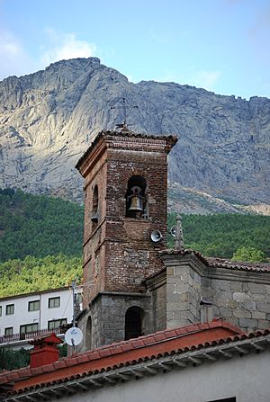 Tower of the church of Cuevas del Valle,in the background the Sierra de Gredos