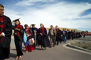 Jill Biden walks with the procession of graduates of the Navajo Technical College Class of 2013