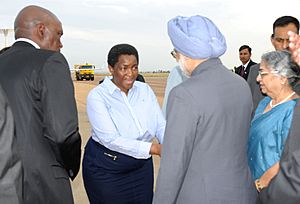 Manmohan Singh and his wife Smt. Gursharan Kaur being received by the Minister for Social Justice, South Africa, Ms. Bathabile Dlamini, on their arrival at Waterkloof Air Force Base, Pretoria for the 5th IBSA Summit.jpg