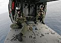 US Navy 040423-N-4190W-001 Search and Rescue Swimmer (SAR) members sit in a MH-60s Knighthawk helicopter during an vertical replenishment