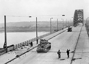 British XXX Corps cross the road bridge at Nijmegen