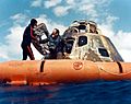 A navy diver helps Ed Mitchell into the recovery raft Ap14-S71-19474