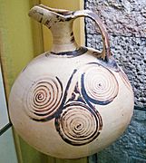Ancient greek beaked jug decorated with triple spirals