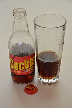 Cockta in bottle and glass with cap